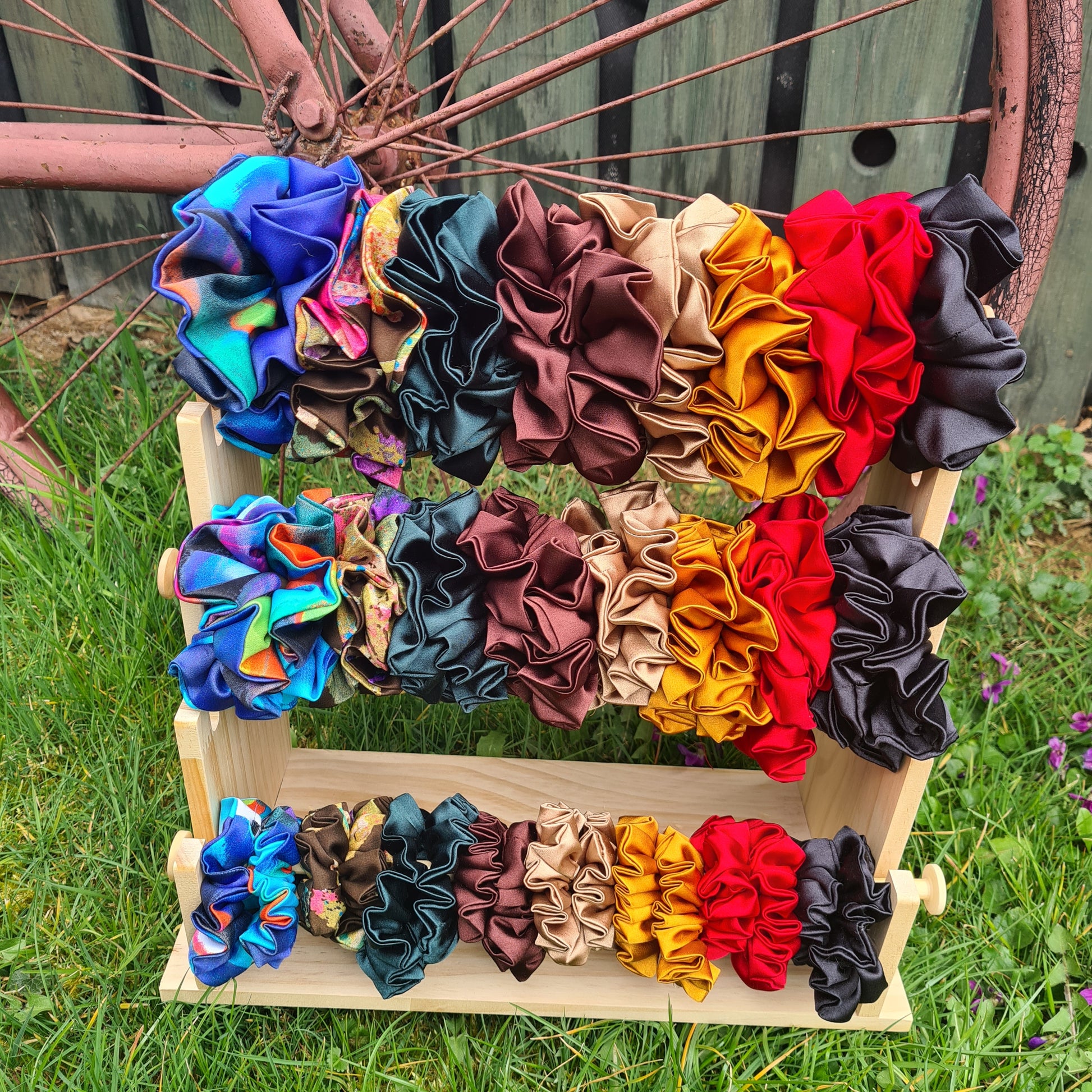 Saténové gumičky do vlasov scrunchie – výber farieb, rôzne veľkosti na stojane, pohľad spredu